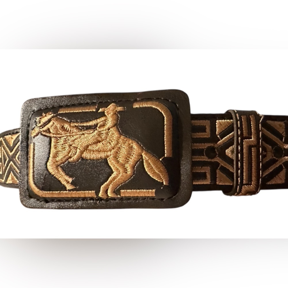 Embroidered horse and rider western leather belt with a removable buckle.